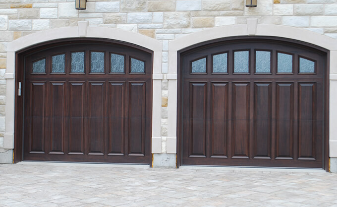 Wooden garage door, Tudor style, Arched with embossed panels and decorative glass, made of solid wood